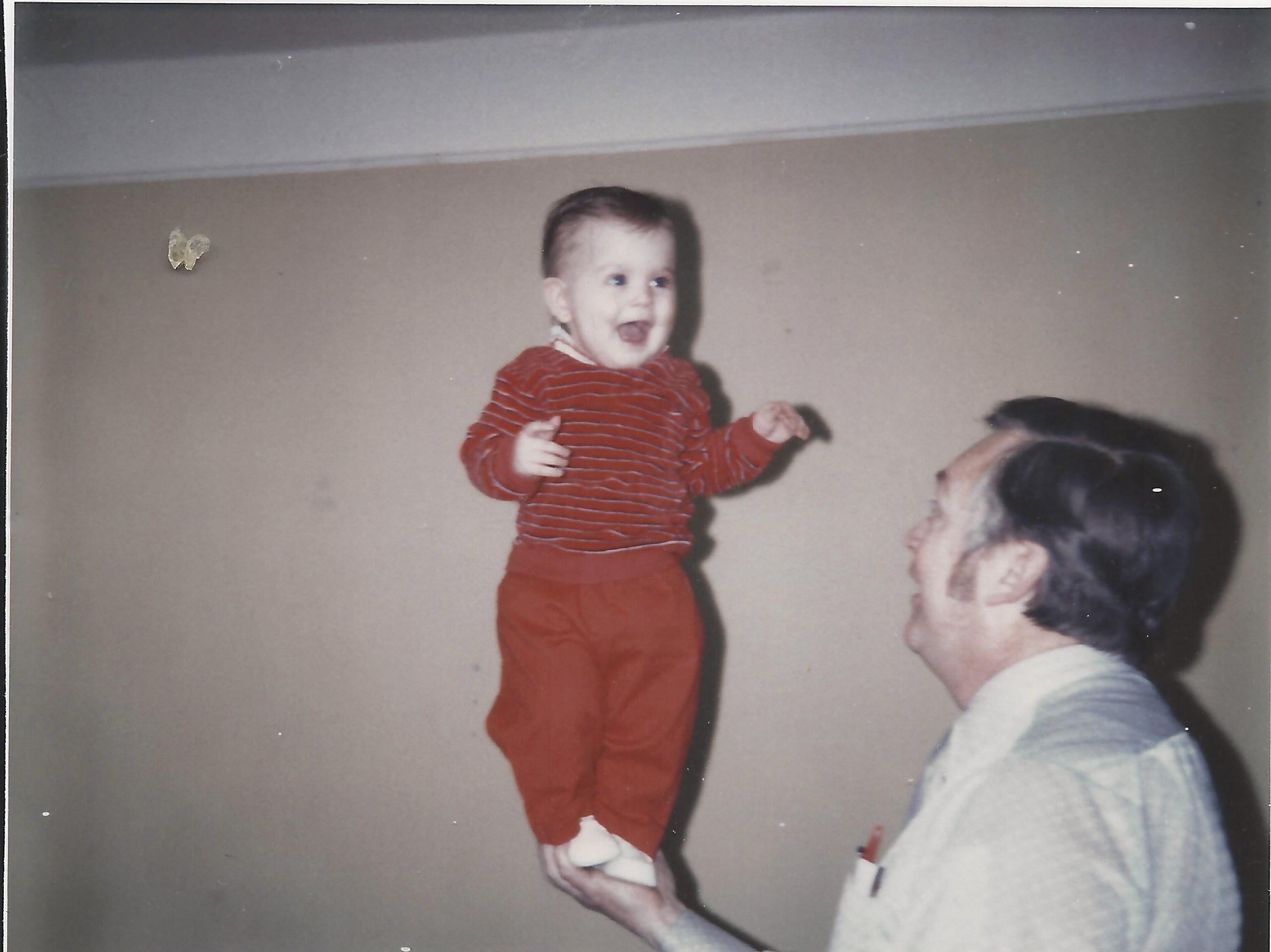 Dad holding me up as a baby.
