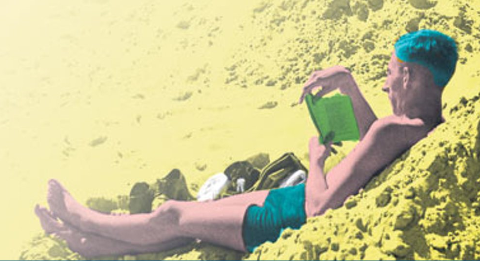 Man-reading-on-a-beach